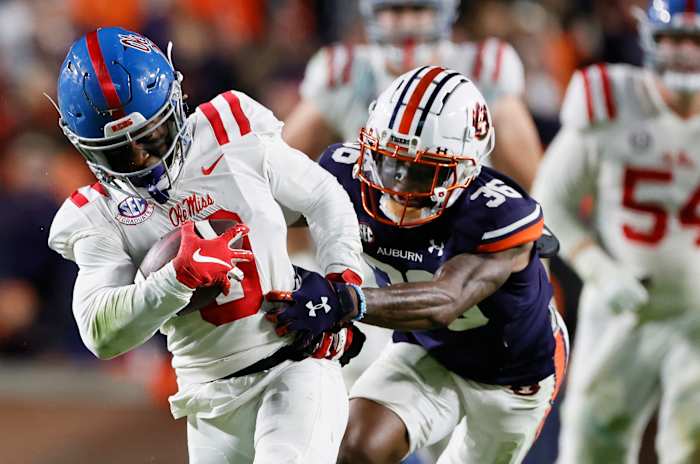 Oct 30, 2021; Auburn, Alabama, USA; Mississippi Rebels wide receiver Jahcour Pearson (0) is tackled by Auburn Tigers cornerback Jaylin Simpson (36) during the fourth quarter at Jordan-Hare Stadium. Mandatory Credit: John Reed-USA TODAY Sports